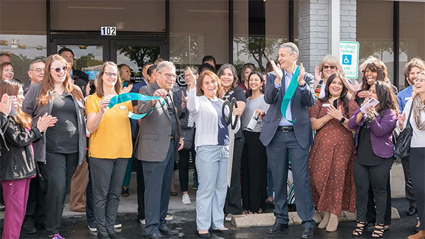 ARC staff and leadership celebrating at a ribbon cutting for an ARC clinic